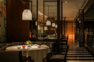 A modern, industrial-themed restaurant with metal, glass, and wooden elements