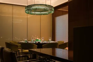 A modern restaurant interior with a glass ceiling and elegant decor.
