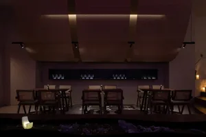 A modern bar interior featuring wood, glass, and metal materials.