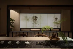 Tea room with wooden elements and traditional Japanese artwork.