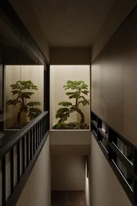 Bonsai tree mounted on a wall in a dark, minimalist interior design setting.