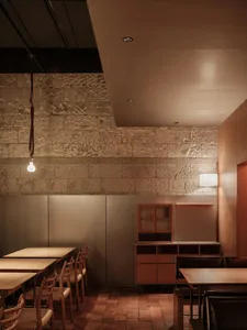 Modern industrial restaurant interior with brick walls, wooden furniture, and metal accents.