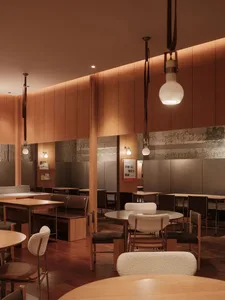Warm and inviting cafe scene with wooden furniture, stone accents, and suspended lighting.