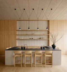Modern kitchen featuring a terrazzo countertop and wooden stools.