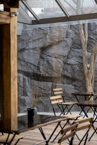 A cafe interior featuring modern wood and stone elements.