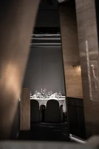 Modern restaurant interior with glass accents and contemporary furniture.
