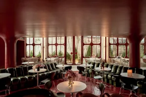 An industrial-themed restaurant interior with metal seating and tables.