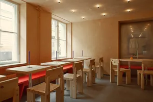 Restaurant with industrial-style wooden furniture and red benches
