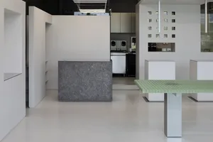 A minimalist coffee shop interior with a concrete counter
