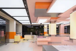 Modern retail storefront with orange tiles and concrete columns