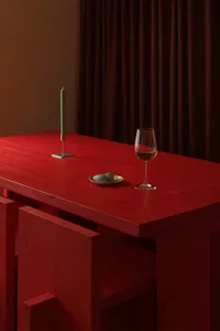 Red wooden bar stools with white cushions in a cozy interior design setting.