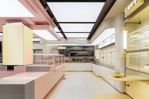 A bakery shop interior featuring pastel tiles and steel elements.
