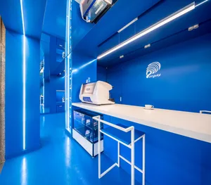Modern cafe shop interior with blue materials and white counter