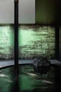 Industrial-style spa room with concrete walls and floor.