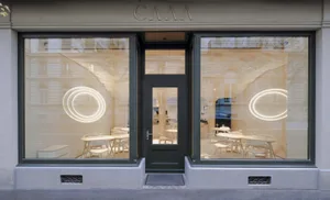 Modern interior of a restaurant with glass and lighting features.