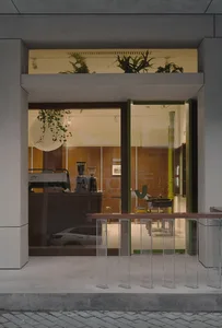 A modern coffee shop with glass and concrete features.