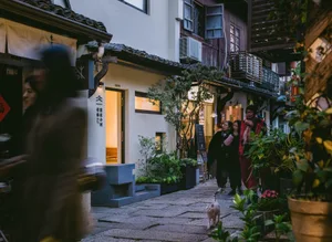 Traditional street scene with historical buildings constructed from stone, wood, and concrete