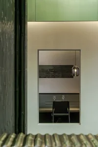 Restaurant interior featuring green structural materials and modern design elements.