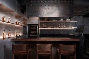 A photograph of an industrial-style bar featuring metallic and wooden elements.