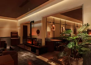 Industrial style lobby featuring concrete walls, wooden furniture, and metal accents.
