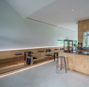 A minimalist cafe interior featuring wooden seating.