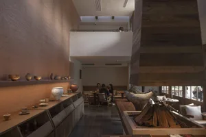 Modern restaurant interior with wooden elements and seating area