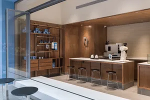 A minimalist coffee shop featuring wooden interior design elements.