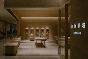 A minimalist retail storefront with wooden shelves and tiled walls.