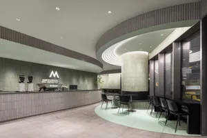 Modern coffee shop featuring sleek, industrial-style design with concrete tiles and glass accents.