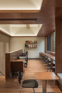 Modern coffee shop interior with wood elements and seating