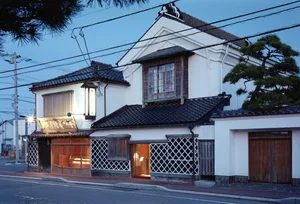 Traditional Japanese residential building constructed with concrete, wood, and metal.