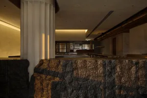 A modern industrial restaurant kitchen with stone countertops