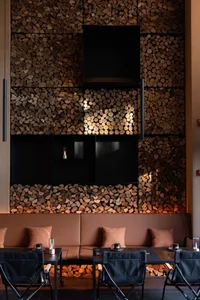 A cozy industrial restaurant interior with wood accents and seating arrangements