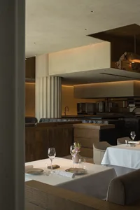 Modern restaurant interior with wood, stone, and metal details