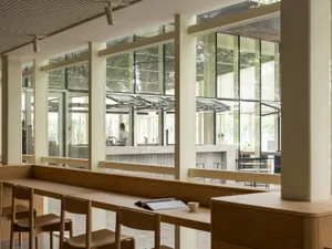 Modern cafe interior with wood accents and large windows