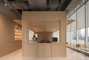 Modern coffee shop interior with wooden paneling and industrial-style furniture