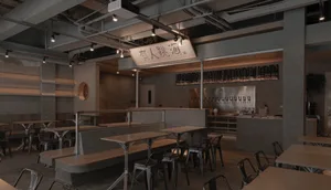 Modern, industrial-style restaurant interior with concrete walls and seating areas.