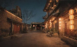 A serene night scene of an ancient town's cobblestone street adorned with illuminated lanterns.