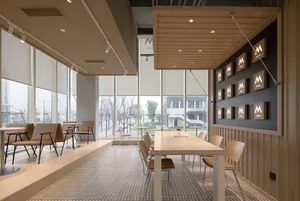 Interior view of a modern cafe with minimalist furniture and a clean, contemporary design.