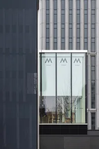 Glass, metal, and concrete facade of a modern office building.