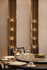 A modern restaurant table setting with marble table and glassware.
