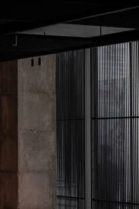 Concrete wall with modern grid pattern and overhead lighting
