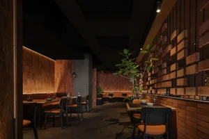 Modern restaurant interior with brick walls, wooden seating, and a minimalist design