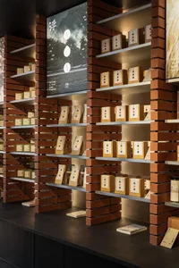 Modern retail store featuring brick and metal shelving displays products.