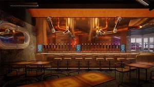 An industrial-themed bar featuring metal pipework and seating.