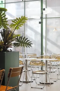 Modern cafe interior with metal and glass furniture and decor