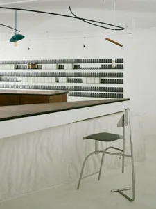 Modern industrial bar with concrete counter and minimalist design.
