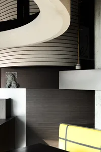 Modern reception desk with a white and black concrete finish and sleek, curved design.