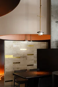 A modern restaurant interior featuring marble accents and minimalist design.