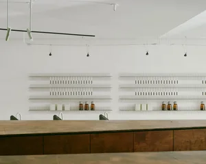 Modern restaurant interior with wooden tables and concrete walls